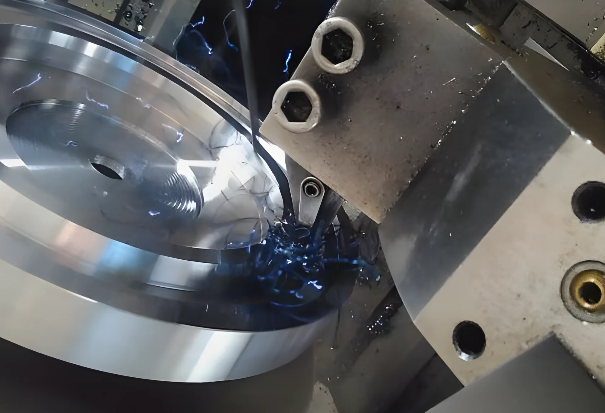 Close-up of a machine turning an aluminum component for a large industrial turntable